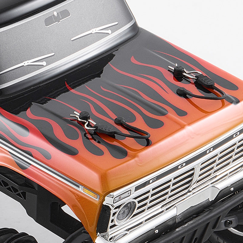 FMS 1:10 Ford F-100 Monster Truck RS with orange flame graphics on hood and chrome grille.
