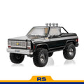 FMS 1:10 scale black Chevrolet K5 Blazer RS with off-road tires and roof lights.