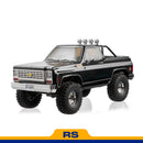 FMS 1:10 scale black Chevrolet K5 Blazer RS with off-road tires and roof lights.