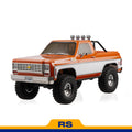 FMS 1:10 FCX10 Chevrolet K5 Blazer RS orange remote control truck with large tires and spotlights.