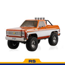 FMS 1:10 FCX10 Chevrolet K5 Blazer RS orange remote control truck with large tires and spotlights.