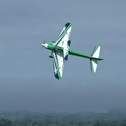 FMS F3A Explorer 1020mm PNP aerobatic RC plane in flight, white with green accents and stars.