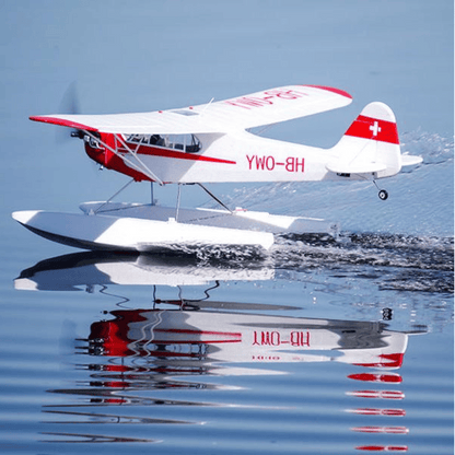 FMS J-3 Cub V4 RC seaplane flying over calm water surface