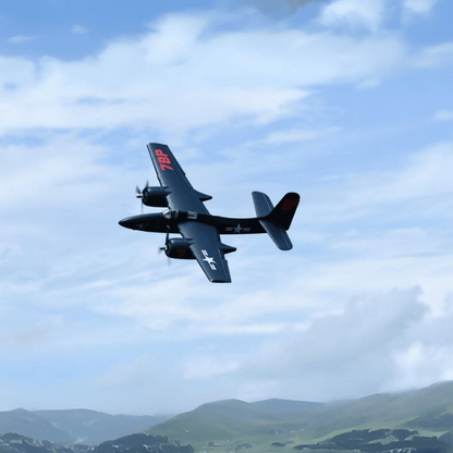 FMS 1700mm F7F Tigercat soaring in the sky above green hills