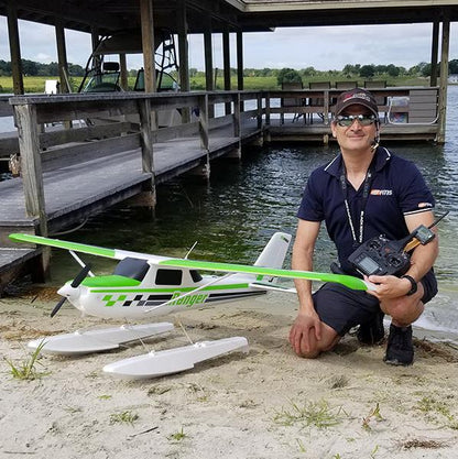 FMS 1800mm Ranger PNP remote control airplane with floats on beach, man holding controller
