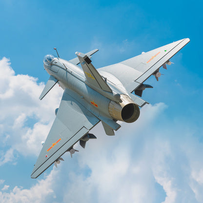 FMS EDF Jet 64mm J-10 PNP model aircraft flying in blue sky with detailed grey finish and weaponry.