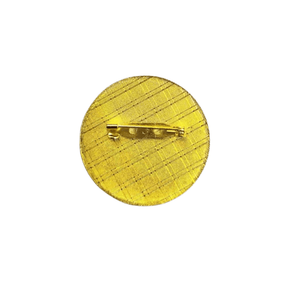 Textured yellow metal pin with safety pin backing for clothing accessories.