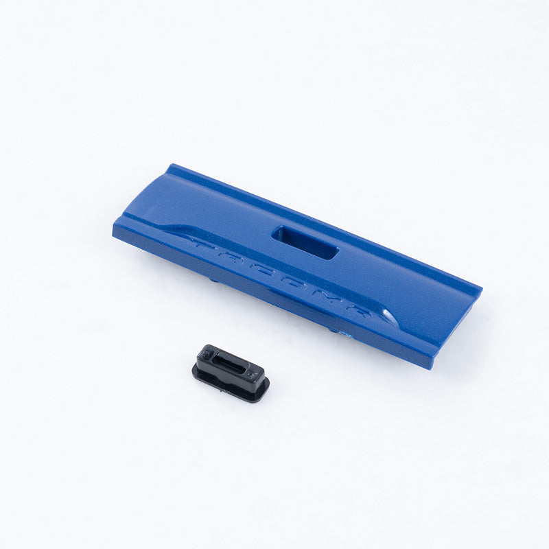 1:24 scale blue Tacoma rear door panel with embossed 'TACOMA' text and black handle.