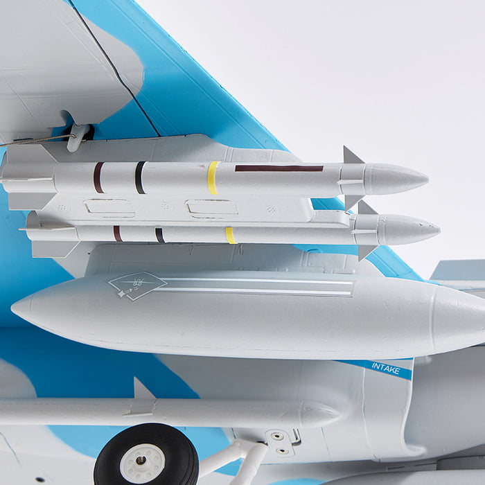 FMS 64mm F/A-18 Hornet jet model with missiles, showing intake detail and blue camouflage pattern.