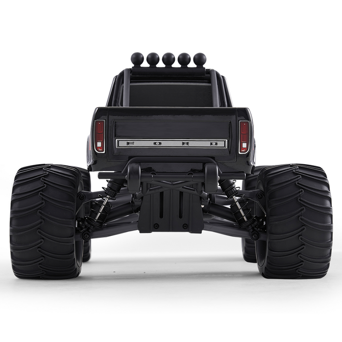 FMS 1:10 Ford F100 Monster Truck rear view, black, large tires, silver 'FORD' lettering