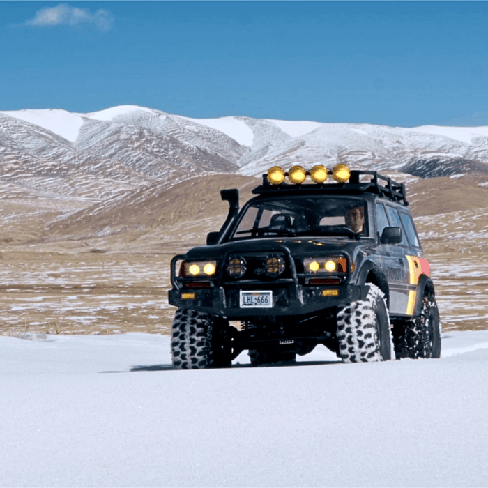 FMS 1:10 FCX10 LC80 Toyota Land Cruiser 80 RS RC crawler in snow with roof rack and off-road lights