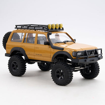 FMS 1:18 scale golden Toyota Land Cruiser 80 V2 RTR RC rock crawler with roof rack and snorkel.