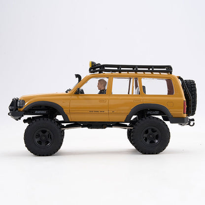 FMS 1:18 LC80 Toyota Land Cruiser 80 V2 RTR yellow RC rock crawler with roof rack and spare tire.