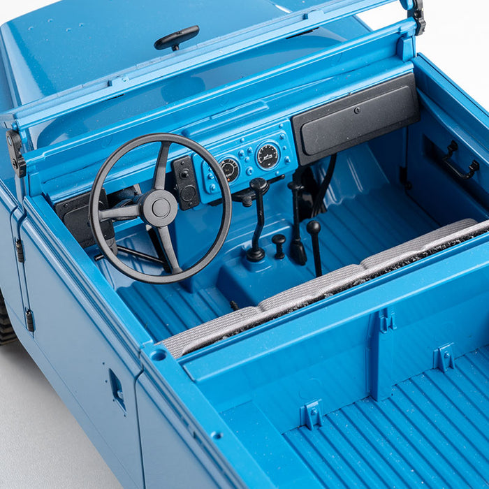 FMS 1:12 Land Rover Series II RTR blue interior, steering wheel, dashboard with gauges, gear shifter, and seats.
