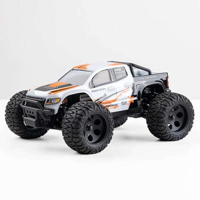 FMS 1:24 FMT24 Chevrolet Colorado Monster Truck RTR in black, white, and orange with large tires