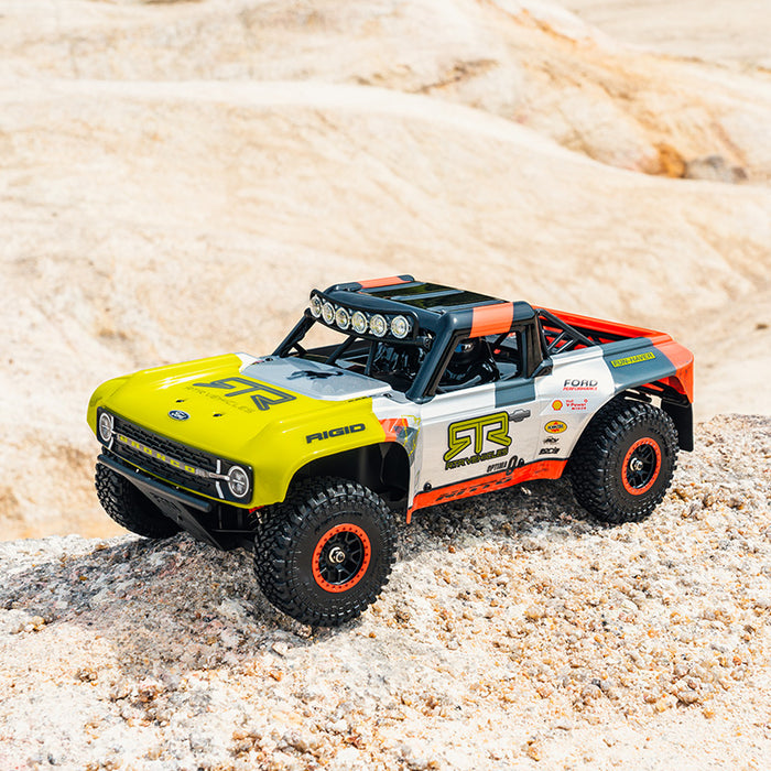 1:18 scale FMS Ford Bronco RTR EB remote control off-road truck with yellow, white, orange livery.