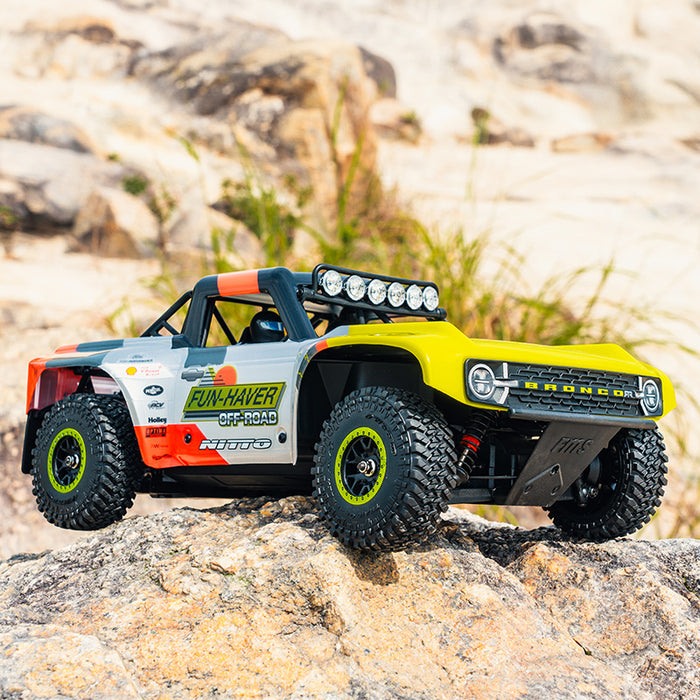 FMS 1:18 Ford Bronco RTR EB RC: Yellow/orange body, Fun-Haver graphics, Nitto tires, roof lights.
