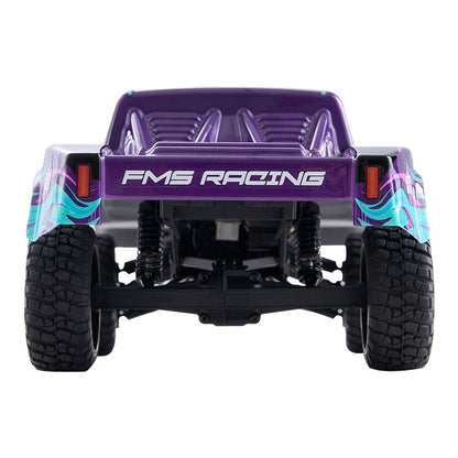 FMS 1:24 scale short course RC truck, purple body with FMS RACING text and teal-pink graphics, rear view.