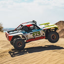 FMS 1:7 Ford Bronco RTR EB Brushless 4WD RS RC truck mid-air jump. White, red, green graphics; "RTR VEHICLE", "NITTO" branding. Off-road.