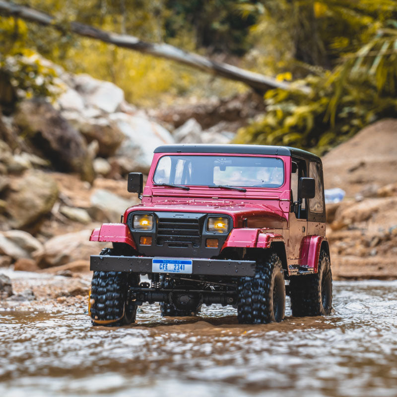 Red ROCHOBBY 1:10 Mashigan RC Rock Crawler RS driving through water with aggressive off-road tires.