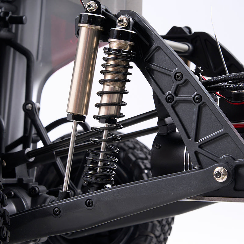 ROCHOBBY 1:7 Ridge Racer U4 desert buggy suspension system with dual gold shock absorbers and black coil springs.