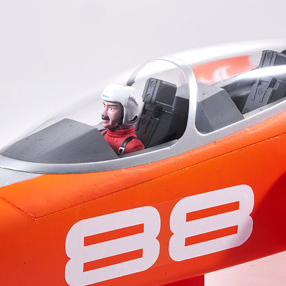 Close-up of FMS Super Scorpion V2 EDF jet cockpit with pilot, bright orange fuselage, and white '38' numbering.