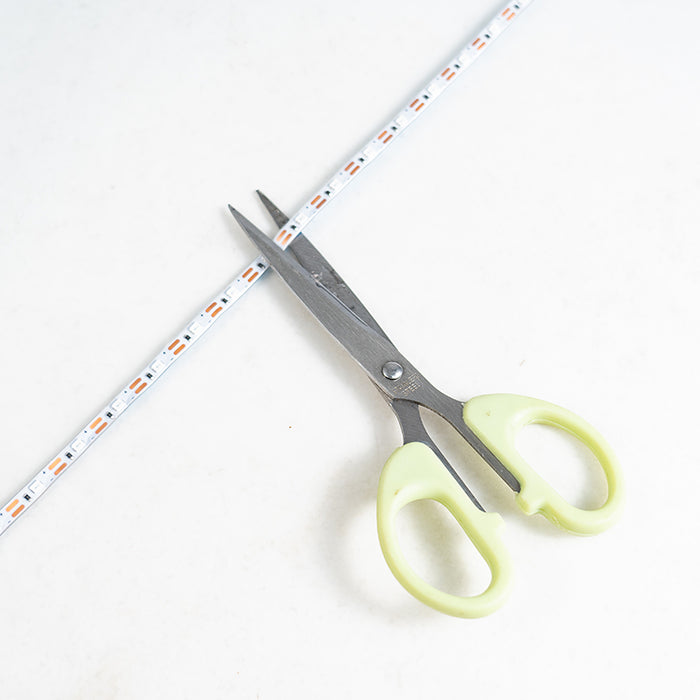 LED light strip being cut with scissors for aeromodelling projects