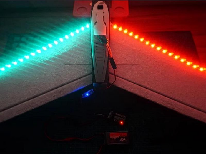 RGB LED light strip on aeromodelling model wing, glowing cyan and red for visibility