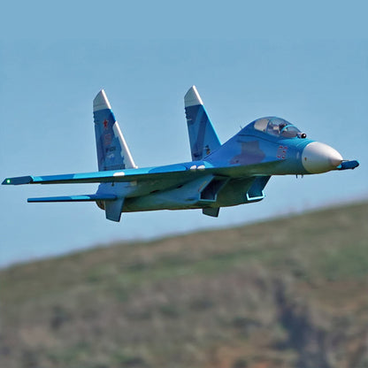 FMS Twin 70mm EDF SU-27 PNP model airplane in blue camouflage, flying in the sky.