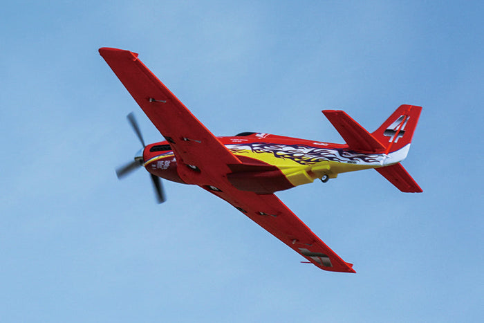 FMS 1100mm P-51 Mustang V2 PNP red and yellow RC airplane with flame decals flying.