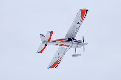 FMS 1400mm Kingfisher PNP remote control airplane in flight, white with orange and blue accents.