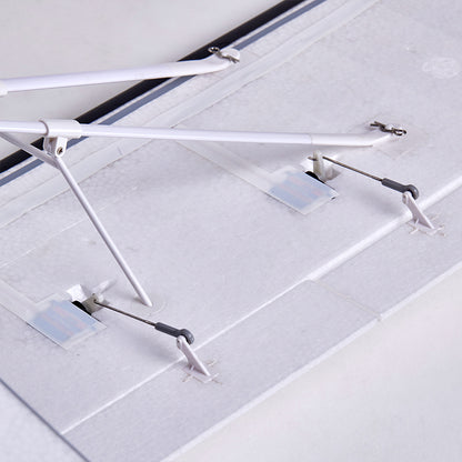 FMS 1300mm PA-18 Super Cub RC airplane wing underside with servo horns and landing gear struts.