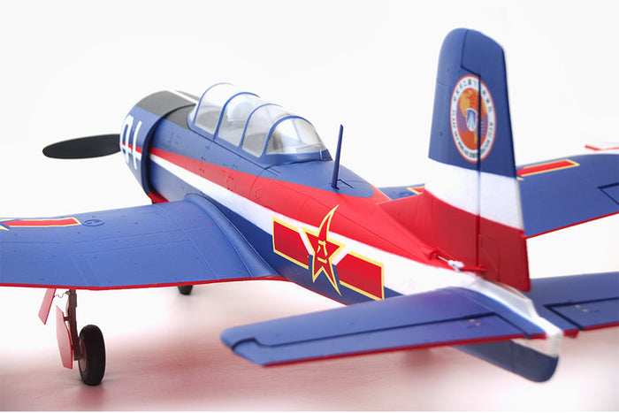 FMS 1200mm CJ6 PNP model airplane with blue, red, and white PLAAF livery and gold star emblem.