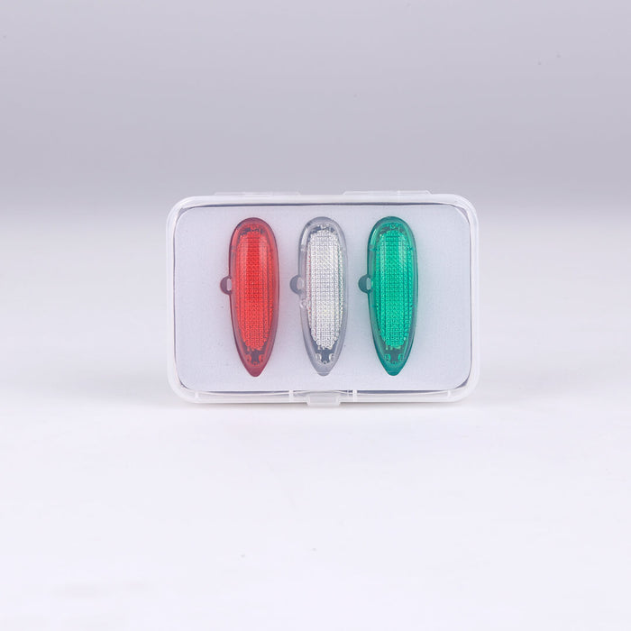 Three aviation lights: red, white, green in transparent packaging