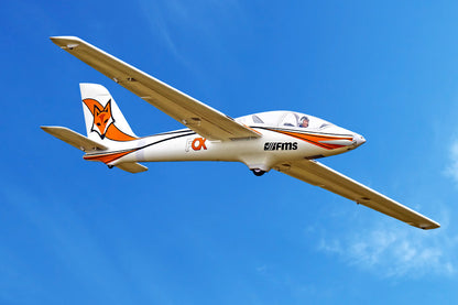 FMS 3000mm Fox aerobatic glider in flight, white with orange fox graphics.