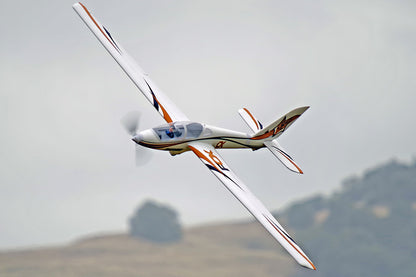 FMS 3000mm Fox Aerobatic glider in flight, white with orange and blue accents, featuring the "FOX" logo.