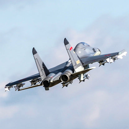 FMS Twin 70mm EDF J-11 PNP model jet in flight with missiles attached.