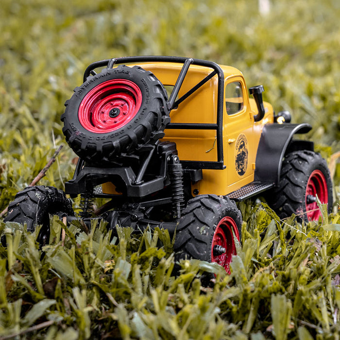 FMS 1:24 FCX24 Power Wagon RTR yellow rock crawler with spare tire in grass