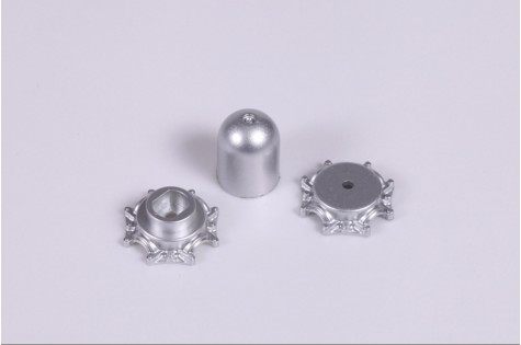 Silver spinner parts for RC models, including a domed cap and base pieces.