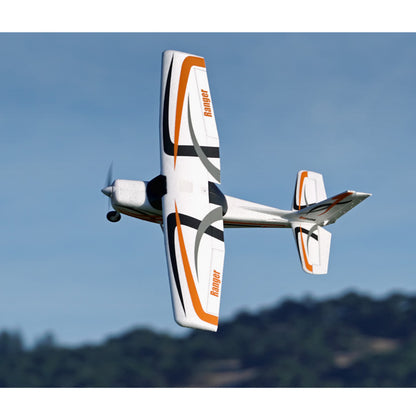 FMS 850mm Ranger RC airplane in flight with orange and black design