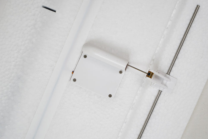 Close-up of FMS 2500mm ASW-17 EP Glider control linkage with white servo cover and silver rod.
