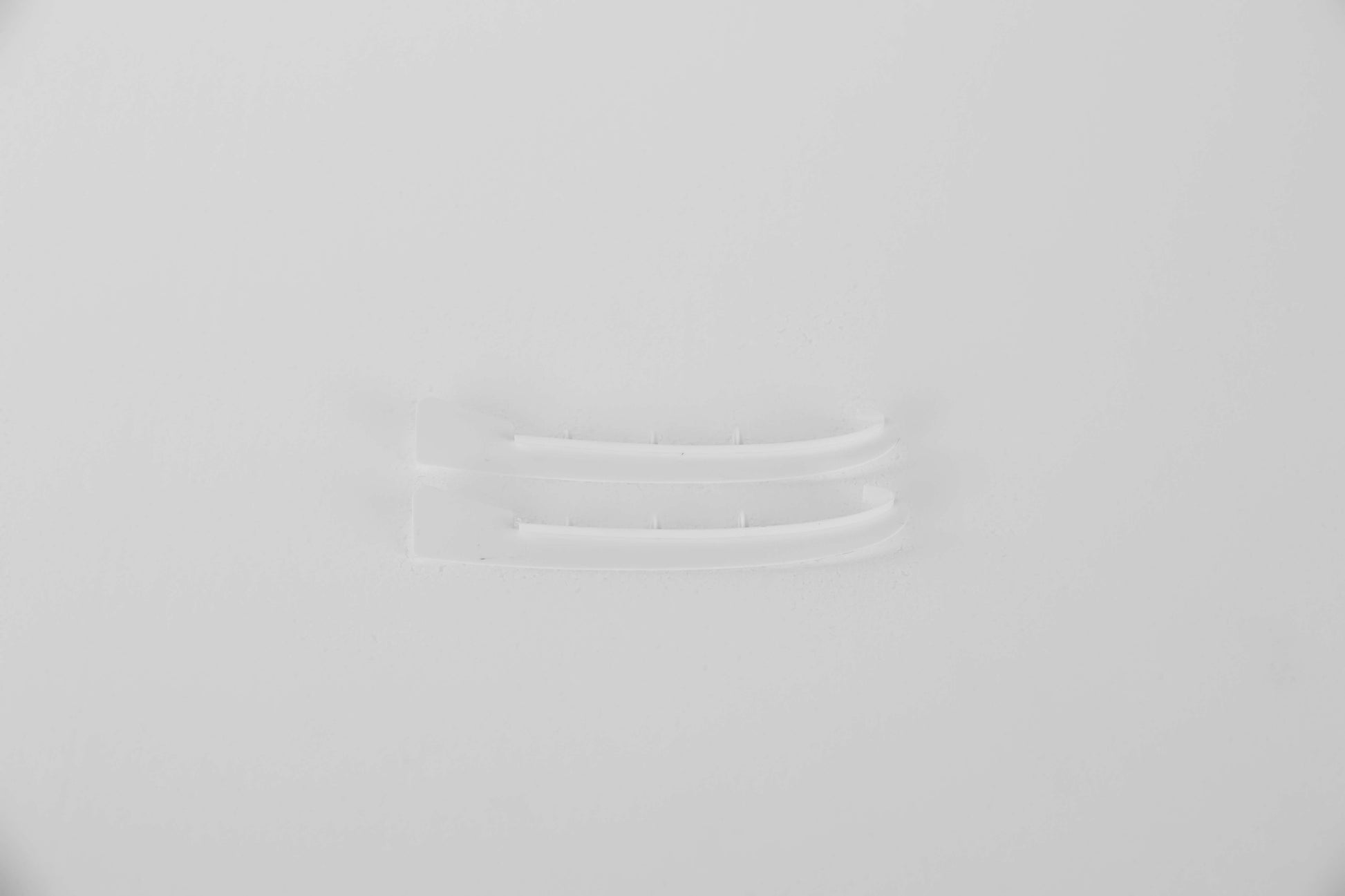 Clear plastic connectors for RC model assembly on a white background