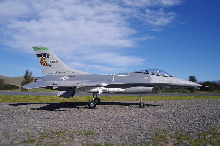 FMS 70mm F-16C Fighting Falcon PNP model jet, grey, with '180FW' and bee logo on tail.
