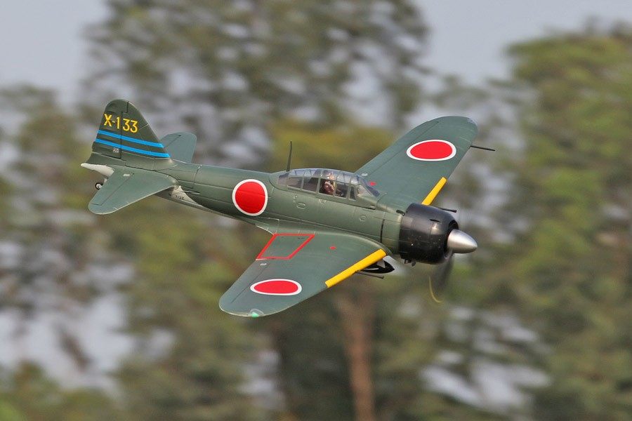 FMS 1400mm A6M3 Zero Green PNP RC airplane in flight, featuring red Hinomaru markings and tail number X-133.