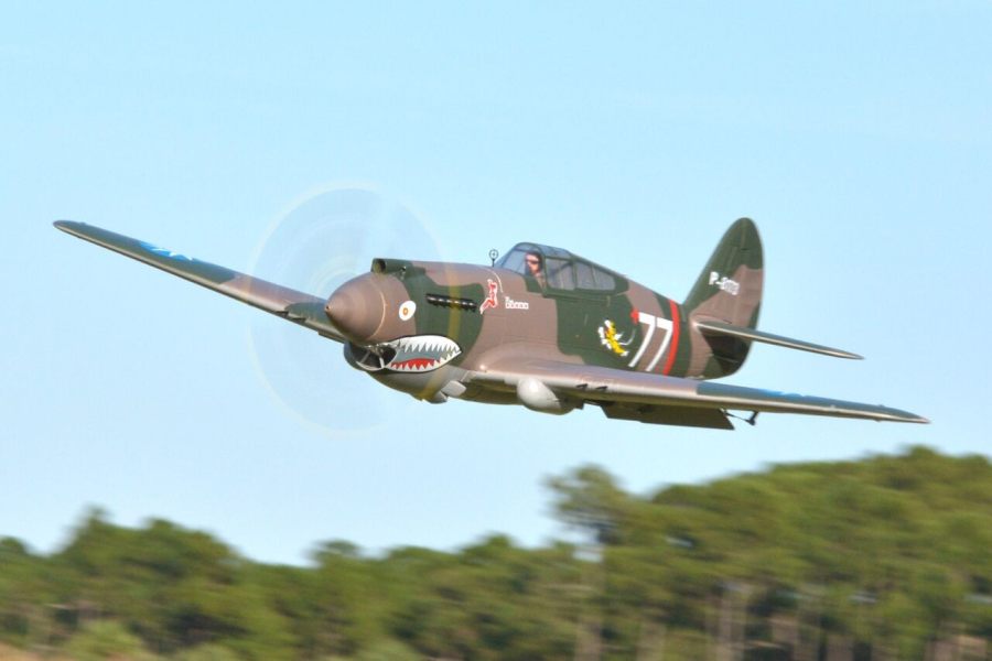 FMS 1400mm P-40B Warhawk Flying Tiger PNP RC plane in flight, featuring shark mouth detail and number 77.