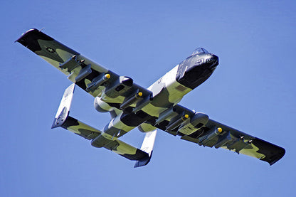 FMS 70mm A-10 Thunderbolt II V2 PNP jet with camouflage paint, weapons, and shark mouth detail flying against blue sky.