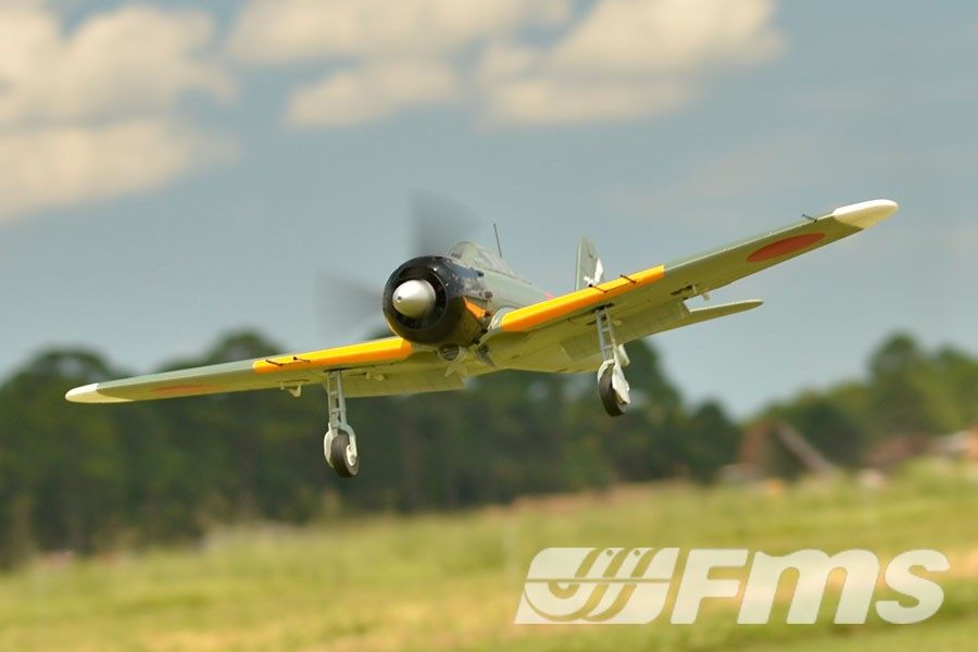 FMS 1100mm A6M5 Zero PNP model airplane in flight, featuring scale details and yellow wing accents.