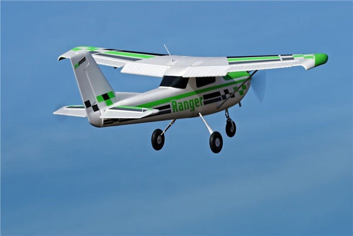 FMS 1800mm Ranger PNP RC airplane flying against a blue sky, featuring white, green, and black livery with "Ranger" text.