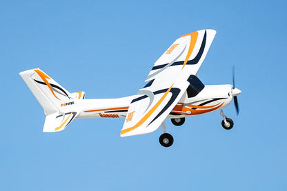 FMS 850mm Ranger RC airplane flying in blue sky with orange and black accents.