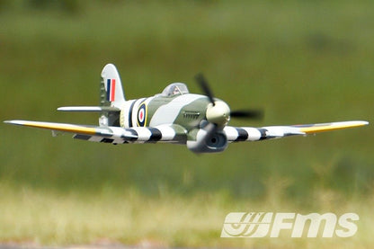 FMS 1100mm Typhoon PNP model airplane in flight, featuring British RAF markings and camouflage.